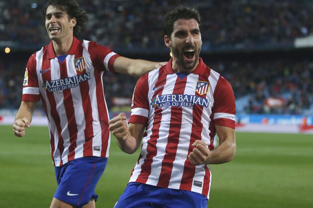 Atletico's Raul Garcia, centre, celebrates his goal with Tiago during a Spanish Copa del Rey soccer match between Atletico de Madrid and Valencia at the Vicente Calderon stadium in Madrid, Spain, Tuesday, Jan. 14, 2014. (AP Photo/Andres Kudacki) Atletico's Raul Garcia, centre, celebrates his goal with Tiago during a Spanish Copa del Rey soccer match between Atletico de Madrid and Valencia at the Vicente Calderon stadium in Madrid, Spain, Tuesday, Jan. 14, 2014. (AP Photo/Andres Kudacki)