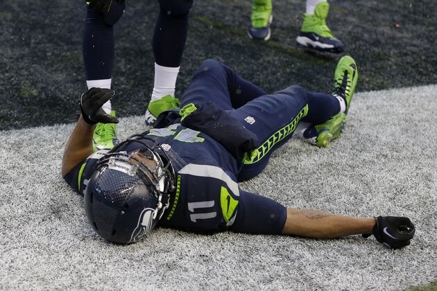 Seattle Seahawks wide receiver Percy Harvin (11) lays on the ground after being injured during the second quarter of an NFC divisional playoff NFL football game against the New Orleans Saints in Seattle, Saturday, Jan. 11, 2014. (AP Photo/Ted S. Warren)