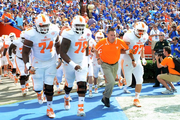 GAINESVILLE, FL - SEPTEMBER 21: Coach Butch Jones of the Tennessee Volunteers leads the team to the field before play against the Florida Gators  September 21, 2013 at Ben Hill Griffin Stadium at Florida Field in Gainesville, Florida.  The Gators won 31 - 17. (Photo by Al Messerschmidt/Getty Images)