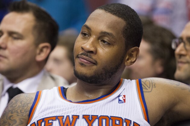 New York Knicks' Carmelo Anthony looks on from the bench during the second half of an NBA basketball game against the Philadelphia 76ers, Saturday, Jan. 11, 2014, in Philadelphia.  The Knicks win 102-92.  (AP Photo/Chris Szagola)
