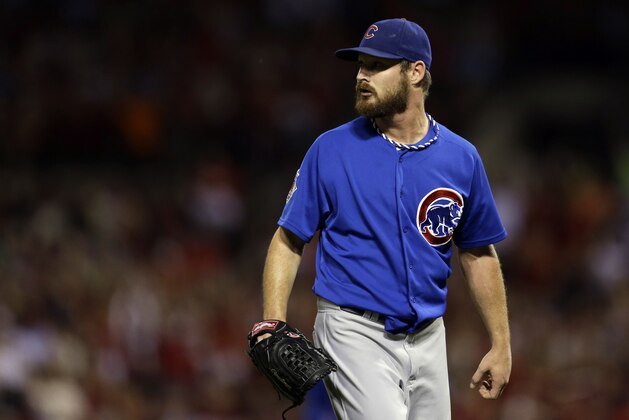 Chicago Cubs starting pitcher Travis Wood watches a ball hit for a two-run double by St. Louis Cardinals' Yadier Molina during the first inning of a baseball game Friday, Sept. 27, 2013, in St. Louis. (AP Photo/Jeff Roberson)