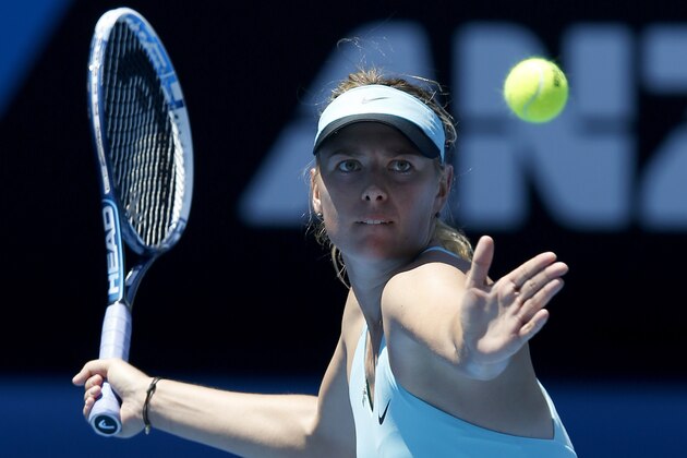 Maria Sharapova of Russia hits a forehand return to Karin Knapp of Italy during their second round match at the Australian Open tennis championship in Melbourne, Australia, Thursday, Jan. 16, 2014.(AP Photo/Eugene Hoshiko)