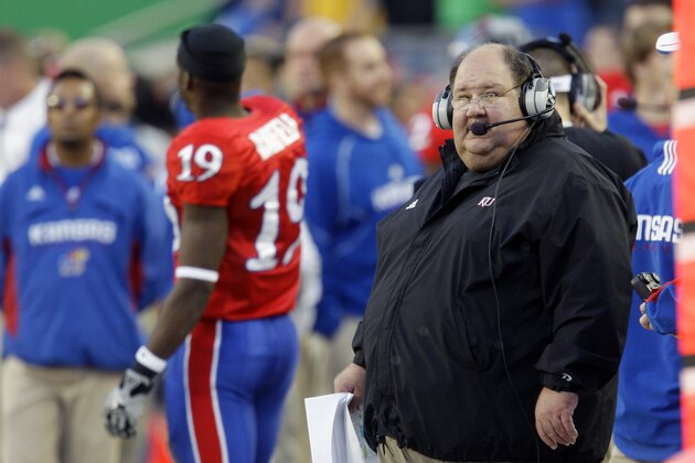 FILE - In this Nov. 28, 2009, file photo, Kansas coach Mark Mangino looks on during the first half of an NCAA college football game against Missouri in Kansas City, Mo. Mangino has resigned two years after leading the Jayhawks to the greatest season in their checkered football history. (AP Photo/Orlin Wagner) FILE - In this Nov. 28, 2009, file photo, Kansas coach Mark Mangino looks on during the first half of an NCAA college football game against Missouri in Kansas City, Mo. Mangino has resigned two years after leading the Jayhawks to the greatest season in their checkered football history. (AP Photo/Orlin Wagner)