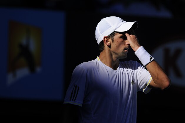 Serbia's Novak Djokovic reacts  as he plays Andy Roddick of the United States in a Men's singles match at the Australian Open Tennis Championship  in Melbourne, Australia, Tuesday, Jan. 27, 2009.  Djokovic retired from the match due to heat stress. (AP Photo/Andrew Brownbill)