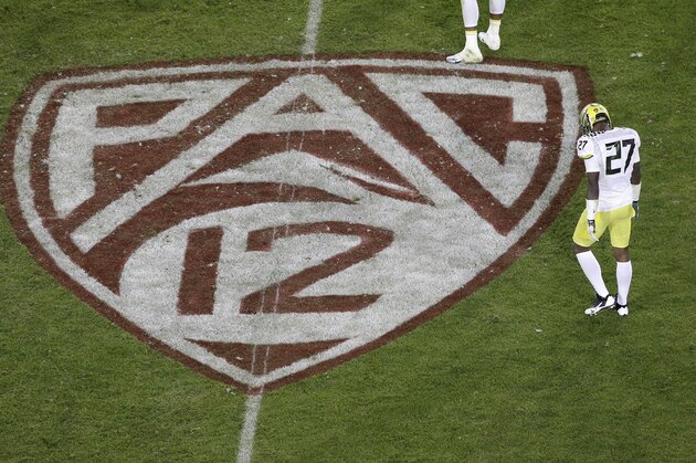 Oregon defensive back Terrance Mitchell (27) walks next to a Pac-12 logo on the field at Stanford Stadium during an NCAA college football game against Stanford in Stanford, Calif., Thursday, Nov. 7, 2013. (AP Photo/Jeff Chiu)