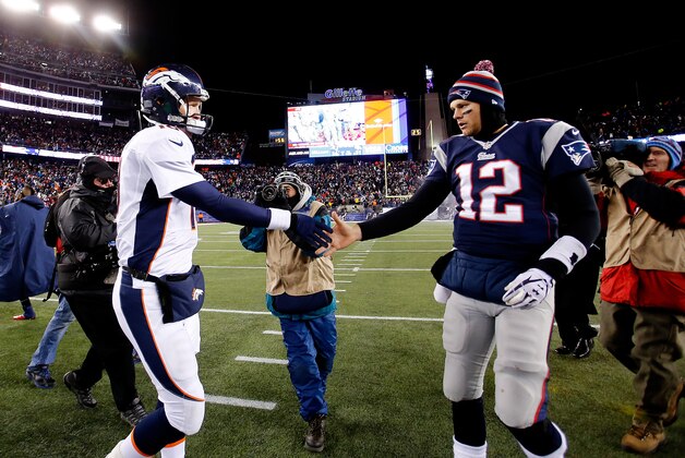 FOXBORO, MA - NOVEMBER 24: Quarterback Peyton Manning #18 of the Denver Broncos and quarterback Tom Brady #12 of the New England Patriots shake hands after the New England Patriots defeated the Denver Broncos 34-31 in overtime at Gillette Stadium on November 24, 2013 in Foxboro, Massachusetts.  (Photo by Jim Rogash/Getty Images)