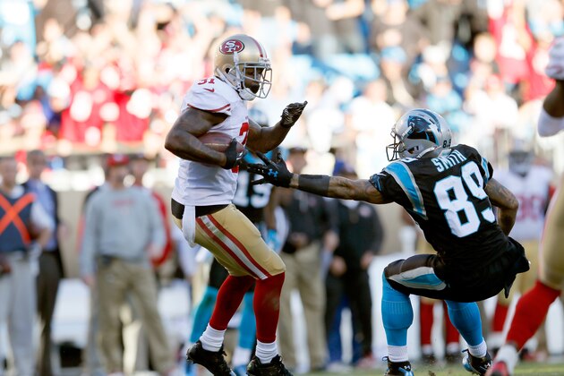 CHARLOTTE, NC - JANUARY 12:  Donte Whitner #31 of the San Francisco 49ers intercepts a pass in the fourth quarter against Steve Smith #89 of the Carolina Panthers during the NFC Divisional Playoff Game at Bank of America Stadium on January 12, 2014 in Charlotte, North Carolina.  (Photo by Kevin C. Cox/Getty Images)