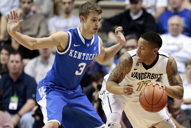 Kentucky guard Jarrod Polson (3) defends Vanderbilt guard Kyle Fuller (11) during the first half of an NCAA college basketball game Saturday, Jan. 11, 2014, in Nashville, Tenn. (AP Photo/Mark Humphrey)