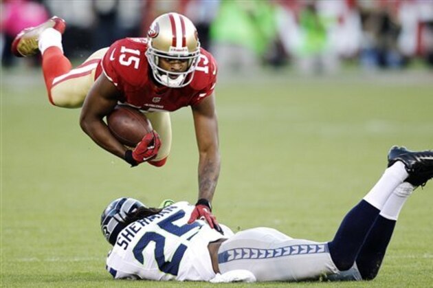 San Francisco 49ers wide receiver Michael Crabtree (15) jumps over Seattle Seahawks cornerback Richard Sherman (25) during the first quarter of an NFL football game in San Francisco, Thursday, Oct. 18, 2012. (AP Photo/Ben Margot)