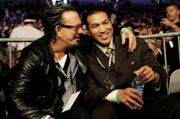 Actor Mickey Rourke, left, hugs kickboxer Ray Sefo at a Strikeforce mixed martial arts event on Saturday, April 11, 2009, in San Jose, Calif. (AP Photo/Jeff Chiu)