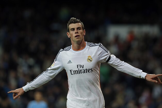 Real Madrid's Gareth Bale celebrates his goal during a Spanish La Liga soccer match between Real Madrid and Valladolid at the Santiago Bernabeu stadium in Madrid, Spain, Saturday, Nov. 30, 2013. (AP Photo/Andres Kudacki)