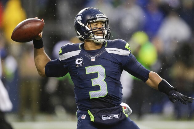 Seattle Seahawks quarterback Russell Wilson (3) passes against the New Orleans Saints during the second half of an NFC divisional playoff NFL football game in Seattle, Saturday, Jan. 11, 2014. (AP Photo/Ted S. Warren)