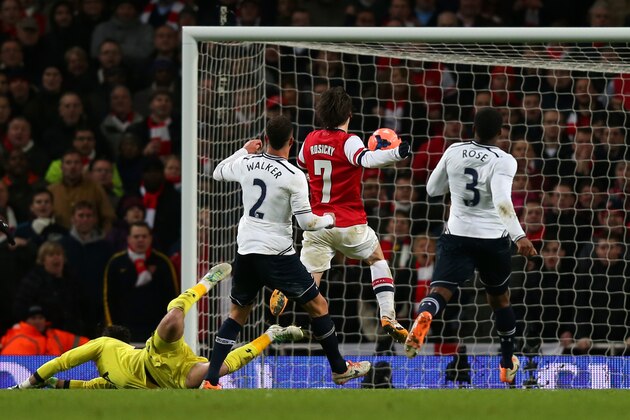 LONDON, ENGLAND - JANUARY 04:  Tomas Rosicky of Arsenal chips the ball over goalkeeper Hugo Lloris of Spurs to score his team'ssecond goal during the Budweiser FA Cup third round match between Arsenal and Tottenham Hotspur at Emirates Stadium on January 4, 2014 in London, England.  (Photo by Clive Rose/Getty Images)