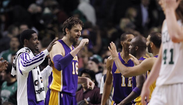 Los Angeles Lakers center Pau Gasol (16) celebrates with teammates after defeating the Boston Celtics 107-104 in an NBA basketball game in Boston, Friday, Jan. 17, 2014. Gasol had 24 points and 13 rebounds in the win. (AP Photo/Charles Krupa)