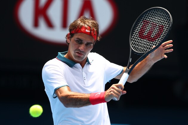 MELBOURNE, AUSTRALIA - JANUARY 18:  Roger Federer of Switzerland plays a backhand in his third round match against Teymuraz Gabashvili of Russia during day six of the 2014 Australian Open at Melbourne Park on January 18, 2014 in Melbourne, Australia.  (Photo by Cassie Trotter/Getty Images)