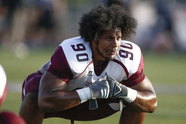 West Texas A&M defensive lineman Ethan Westbrooks (90) stretches during pre-game warmups before an NCAA football game against Tarleton State, Saturday, Oct. 12, 2013, in Stephenville, Texas. (AP Photo/Jim Cowsert)