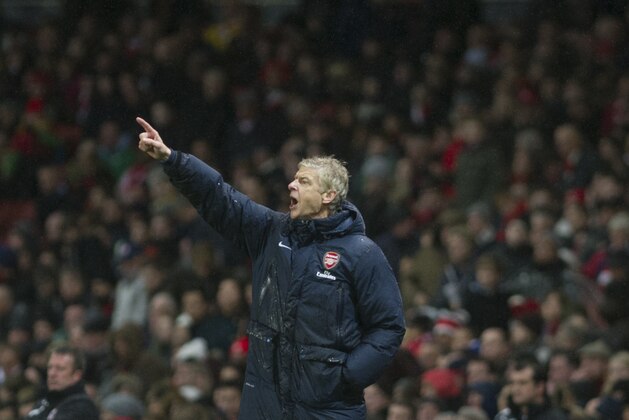 Arsenal's manager Arsene Wenger, reacts on during their English Premier League match against Cardiff City, at Emirates Stadium, in London, Wednesday, Jan. 1, 2014. (AP Photo/Bogdan Maran)