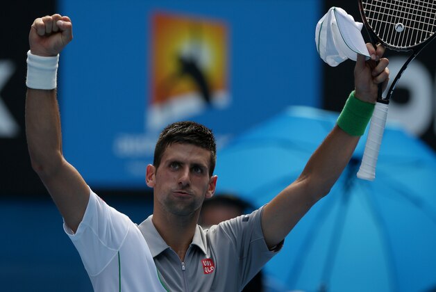 Novak Djokovic of Serbia waves to the crowd after winning his second round match against Leonardo Mayer of Argentina at the Australian Open tennis championship in Melbourne, Australia, Wednesday, Jan. 15, 2014.(AP Photo/Aaron Favila)