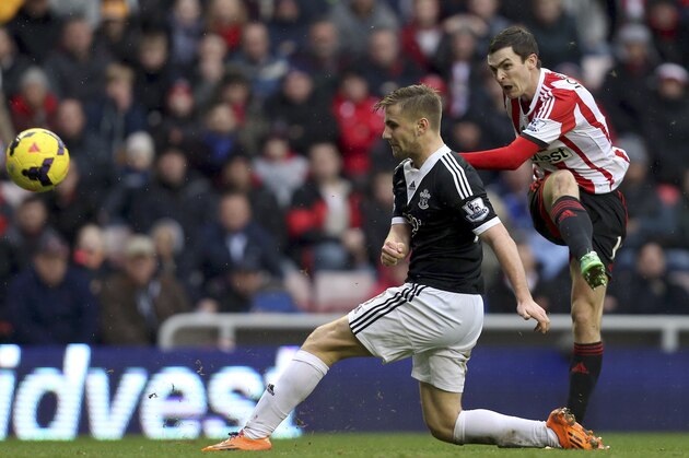 Sunderland's Adam Johnson, right, scores his goal past Southampton's Luke Shaw, during their English Premier League soccer match at the Stadium of Light, Sunderland, England, Saturday, Jan. 18, 2014. (AP Photo/Scott Heppell)