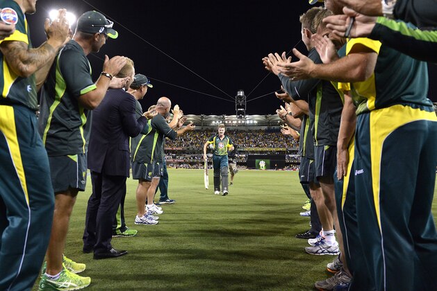BRISBANE, AUSTRALIA - JANUARY 17:  James Faulkner of Australia is cheered off by team mates after hitting the winning runs after during the second game of the One Day International Series between Australia and England at The Gabba on January 17, 2014 in Brisbane, Australia.  (Photo by Bradley Kanaris/Getty Images)