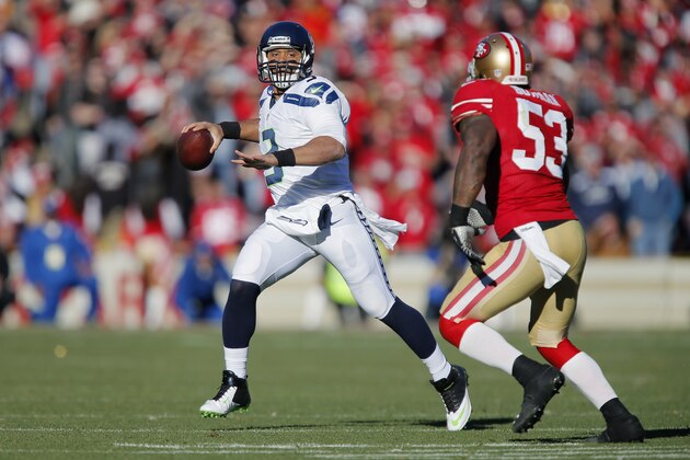 SAN FRANCISCO, CA - DECEMBER 08:  Quarterback Russell Wilson #3 of the Seattle Seahawks looks for a receiver against linebacker NaVorro Bowman #53 of the San Francisco 49ers in the second quarter on December 8, 2013 at Candlestick Park in San Francisco, California.  The 49ers won 19-17.  (Photo by Brian Bahr/Getty Images)