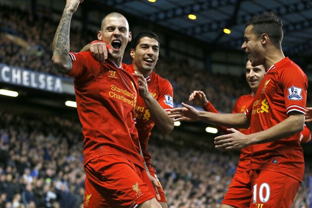 Liverpool's Martin Skrtel, left, celebrates with teammates after scoring a goal during the English Premier League soccer match between Chelsea and Liverpool at Stamford Bridge Stadium in London, Sunday, Dec. 29, 2013. (AP Photo/Kirsty Wigglesworth)