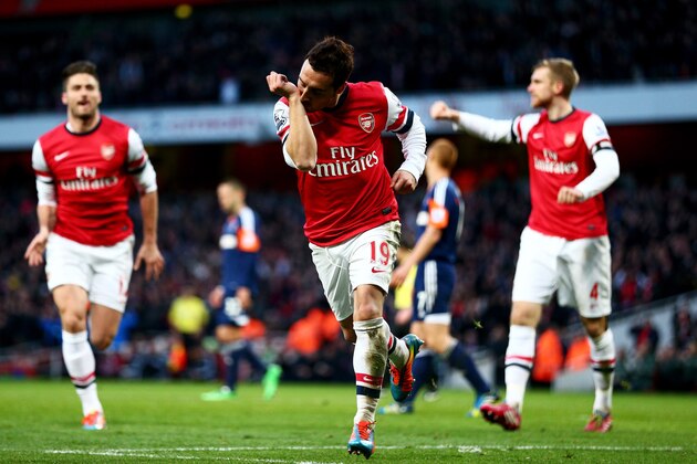 LONDON, ENGLAND - JANUARY 18:  Santi Cazorla of Arsenal (C) celebrates as he scores their first goal during the Barclays Premier League match between Arsenal and Fulham at Emirates Stadium on January 18, 2014 in London, England.  (Photo by Clive Mason/Getty Images)