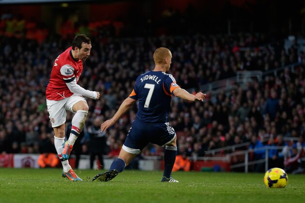 Arsenal's Santi Cazorla, left, scores his side's second goal past Fulham's Steve Sidwell during the English Premier League soccer match between Arsenal and Fulham at the Emirates Stadium in London, Saturday, Jan. 18, 2014.  (AP Photo/Matt Dunham)