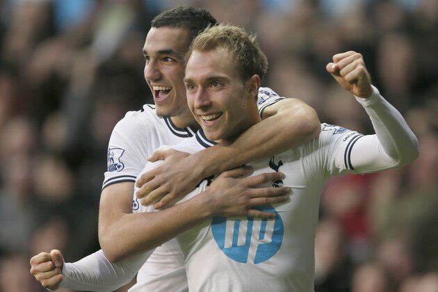 Tottenham's Christian Eriksen, right, celebrates after scoring a goal against Crystal Palace during their English Premier League soccer match at the White Hart Lane stadium in London, Saturday, Jan. 11, 2014. (AP Photo/Alastair Grant)