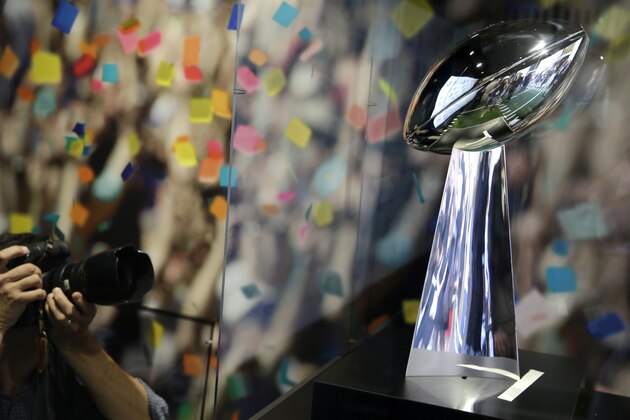 A photographer takes pictures of the Vince Lombardi trophy during a news conference at Tiffany & Co. in New York, Wednesday, Sept. 4, 2013. The retrieval of the trophy from Tiffany & Co. is one of many events leading up to the Super Bowl in New Jersey on Feb. 2, 2014. (AP Photo/Seth Wenig)