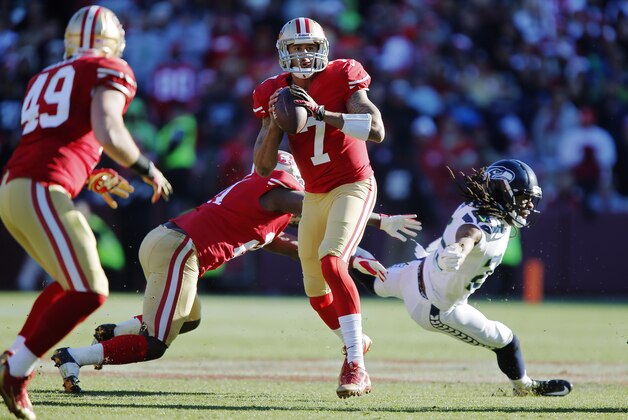 SAN FRANCISCO, CA - DECEMBER 08:  Quarterback Colin Kaepernick #7 of the San Francisco 49ers looks for wide receiver Michael Crabtree as he steps out of the way of cornerback Richard Sherman #25 of the Seattle Seahawks in the second quarter on December 8, 2013 at Candlestick Park in San Francisco, California.  The 49ers won 19-17.  (Photo by Brian Bahr/Getty Images)