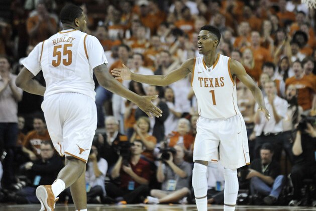 Jan 18, 2014; Austin, TX, USA; Texas Longhorns guard Isaiah Taylor (1) and center Cameron Risley (55) react against the Iowa State Cyclones during the second half at the Frank Erwin Special Events Center. Texas beat Iowa State 86-76. Mandatory Credit: Brendan Maloney-USA TODAY Sports