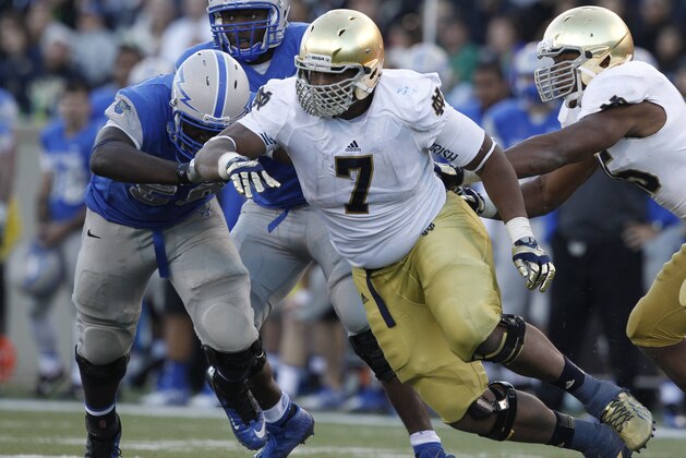 Notre Dame defensive lineman Stephon Tuitt, right, battles for position with Air Force offensive lineman Moshood Adeniji in the third quarter of Notre Dame's 45-20 victory in an NCAA football game at the Air Force Academy, Colo., on Saturday, Oct. 26, 2013. (AP Photo/David Zalubowski)