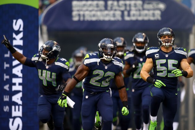 SEATTLE, WA - SEPTEMBER 15:   Spencer Ware #44, Robert Turbin #22 and  Heath Farwell #55 of the Seattle Seahawks run on to the field during their game against the San Francisco 49ers at Qwest Field on September 15, 2013 in Seattle, Washington.  (Photo by Jonathan Ferrey/Getty Images)