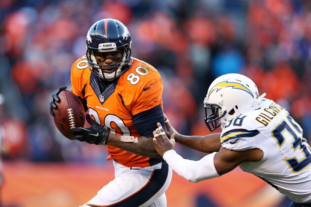 DENVER, CO - JANUARY 12:  Julius Thomas #80 of the Denver Broncos tries to avoid the tackle of  Marcus Gilchrist #38 of the San Diego Chargers during the AFC Divisional Playoff Game at Sports Authority Field at Mile High on January 12, 2014 in Denver, Colorado.  (Photo by Christian Petersen/Getty Images)