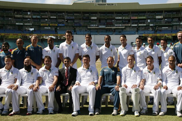 South Africa's cricket team and technical staff, Front Row L-R Morne Morkel, Hashim Amla, Jacques Kallis, Mohammed Moosajee (team manager/doctor), captain Graeme Smith, Russell Domingo (Head Coach), Abraham Benjamin de Villiers, Dale Steyn and Alviro Petersen. Back Row L-R, Lerato Malekutu (Media officer), Prasanna Angoram (Video Analyst), Zunaid Wadee (Close Protection Officer), Adrian Birrell (Assistant Coach), Vernon Philander, Kyle Abbott, Rory Kleinveldt, Robin Peterson, Francois du Plessis, Jean-Paul Duminy,  Imran Tahir, Dean Elgar, Allan Donald (specialist bowling coach), Brandon Jackson (physiotherapist), Greg King (Conditioning coach) and Riaan Muller (team logistics), pose for a photograph before their fifth and final day of their cricket test match against India at Kingsmead stadium, Durban, South Africa, Monday, Dec. 30, 2013. South Africa beat India by 10 wickets. (AP Photo/ Themba Hadebe)