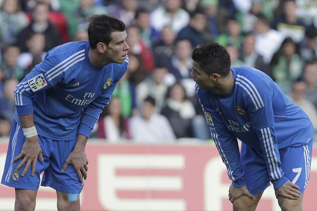 Real Madrid's Cristiano Ronaldo, right, talks with teammate Gareth Bale, left, during their La Liga soccer match against Betis at the Benito Villamarin stadium, in Seville, Spain on Saturday, Jan. 18, 2014. (AP Photo/Angel Fernandez)