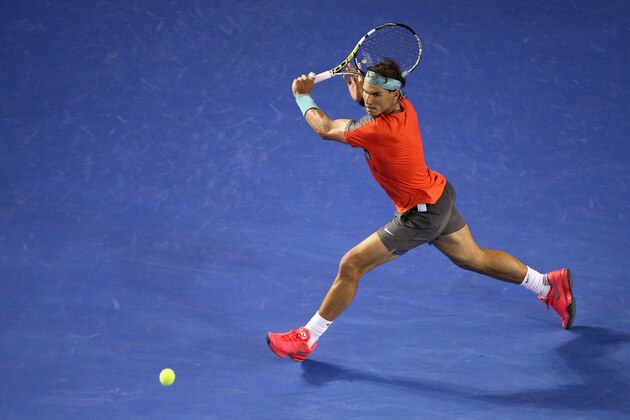 MELBOURNE, AUSTRALIA - JANUARY 18:  Rafael Nadal of Spain runs to play a backhand during his straight sets victory in his third round match against Gael Monfils of France during day six of the 2014 Australian Open at Melbourne Park on January 18, 2014 in Melbourne, Australia.  (Photo by Clive Brunskill/Getty Images)