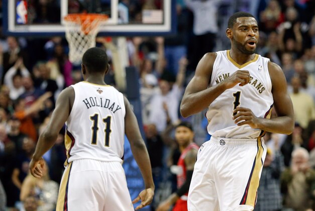 Dec 30, 2013; New Orleans, LA, USA; New Orleans Pelicans point guard Tyreke Evans (1) celebrates with teammate point guard Jrue Holiday (11) after hitting a shot to take the lead with 1.2 seconds remaining in the fourth quarter of a game against the Portland Trail Blazers at the New Orleans Arena. The Pelicans defeated the Trail Blazers 110-108. Mandatory Credit: Derick E. Hingle-USA TODAY Sports