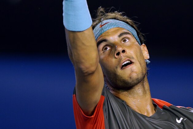 Rafael Nadal of Spain serves to Gael Monfils of France during their third round match at the Australian Open tennis championship in Melbourne, Australia, Saturday, Jan. 18, 2014.(AP Photo/Aaron Favila)