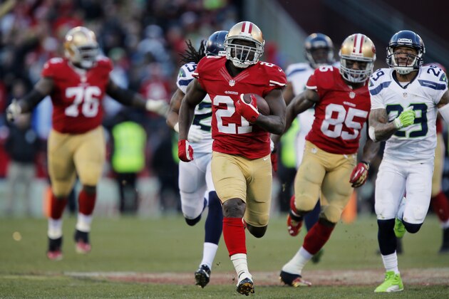 SAN FRANCISCO, CA - DECEMBER 08:  Running back Frank Gore #21 of the San Francisco 49ers breaks free for a 51-yard run as tight end Vernon Davis #85 blocks cornerback Richard Sherman #25 and free safety Earl Thomas #29 of the Seattle Seahawks before pulling up short of a touchdown to run down the clock late in the fourth quarter on December 8, 2013 at Candlestick Park in San Francisco, California.  The play set up the winning field goal as the 49ers won 19-17.  (Photo by Brian Bahr/Getty Images)