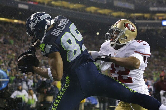 Seattle Seahawks' Doug Baldwin (89) comes down with a touchdown catch past the defense of San Francisco 49ers' Carlos Rogers (22) in the second half of an NFL football game, Sunday, Dec. 23, 2012, in Seattle. (AP Photo/Elaine Thompson)