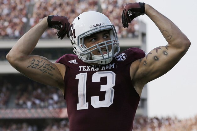 Texas A&M wide receiver Mike Evans (13) celebrates his 95-yard touchdown against Alabama during the fourth quarter of an NCAA college football game Saturday, Sept. 14, 2013, in College Station, Texas. (AP Photo/David J. Phillip)