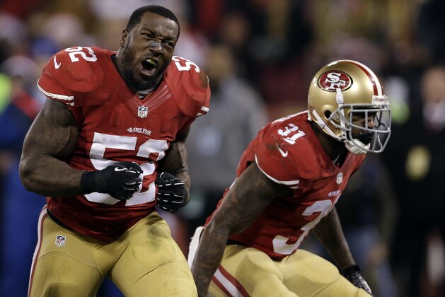 San Francisco 49ers Patrick Willis (52) and Donte Whitner celebrate after teammate NaVorro Bowman made an 89-yard touchdown in the fourth quarter of an NFL football game against the Atlanta Falcons in San Francisco, Monday, Dec. 23, 2013. (AP Photo/Marcio Jose Sanchez)