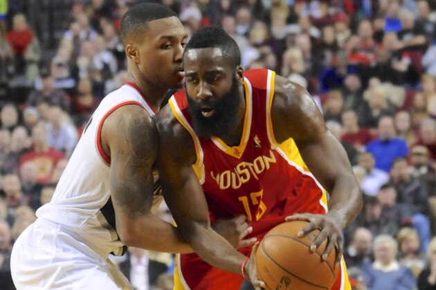 Houston Rockets' James Harden (13) looks to pass  against Portland Trail Blazers'  Damian Lillard (0) during the first half of an NBA basketball game in Portland, Ore.,Thursday Dec. 12, 2013. (AP Photo/Greg Wahl-Stephens)