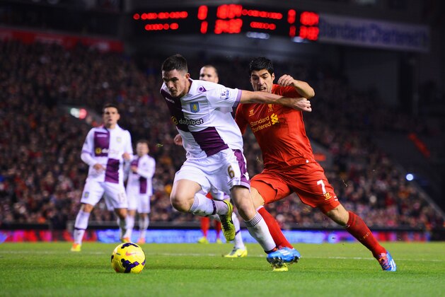 LIVERPOOL, ENGLAND - JANUARY 18:  Luis Suarez of Liverpool challenges Ciaran Clark of Aston Villa during the Barclays Premier League match between Liverpool and Aston Villa at Anfield on January 18, 2014 in Liverpool, England.  (Photo by Michael Regan/Getty Images)