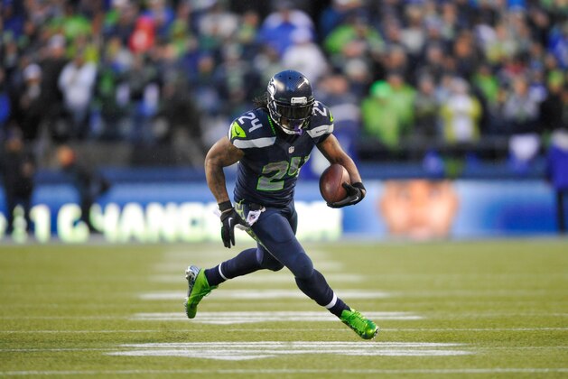 Jan 11, 2014; Seattle, WA, USA; Seattle Seahawks running back Marshawn Lynch (24) carries the ball against the New Orleans Saints during the second half of the 2013 NFC divisional playoff football game at CenturyLink Field. Seattle defeated New Orleans 23-15. Mandatory Credit: Steven Bisig-USA TODAY Sports