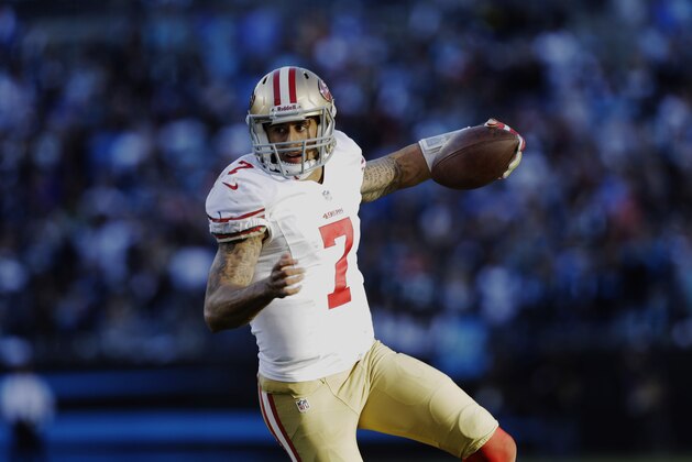San Francisco 49ers quarterback Colin Kaepernick (7) carries the ball against the Carolina Panthers during the second half of a divisional playoff NFL football game, Sunday, Jan. 12, 2014, in Charlotte, N.C. (AP Photo/Gerry Broome)