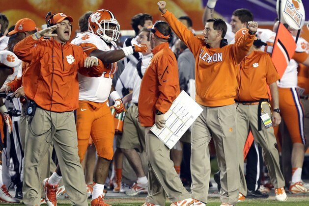 Clemson head coach Dabo Swinney, right, celebrates in the final minutes of the Orange Bowl NCAA college football game against Ohio State, Saturday, Jan 4, 2014, in Miami Gardens, Fla. Clemson defeated Ohio State 40-35.  (AP Photo/Wilfredo Lee)