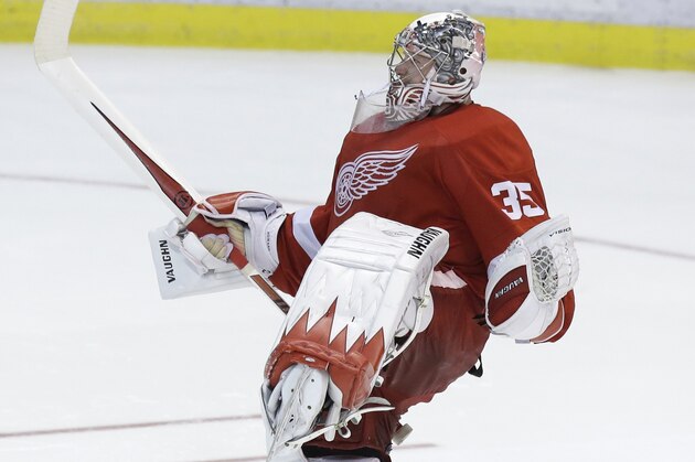 Detroit Red Wings goalie Jimmy Howard (35) celebrates after a 3-2 win after the shootout period of an NHL hockey game against the Los Angeles Kings in Detroit, Saturday, Jan. 18, 2014. (AP Photo/Carlos Osorio)
